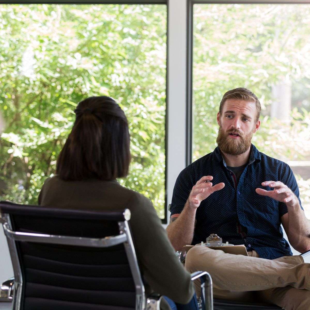Mindful Healing Dissociative Identity Disorder DID Treatment in New Jersey Male therapist talking to a female patient in an office setting