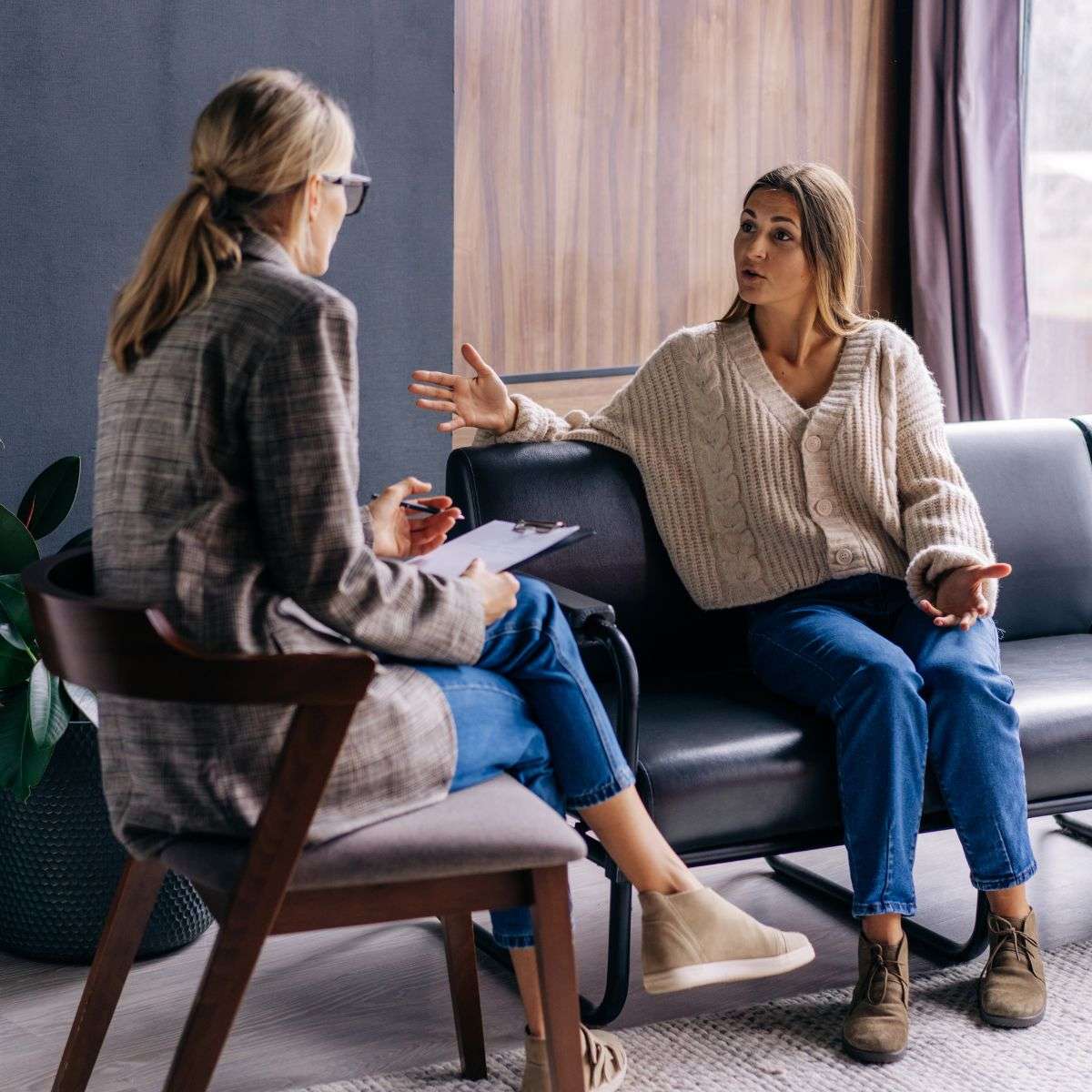 Mindful Healing Dissociative Identity Disorder DID Treatment in New Jersey woman on a couch sitting and talking to a female therapist about her struggles