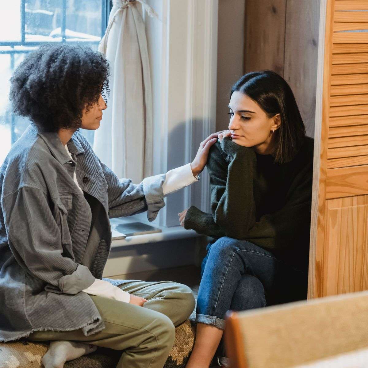 Mindful Healing Family Therapy in New Jersey two women talking, one african american woman, one middle eastern woman who looks upset