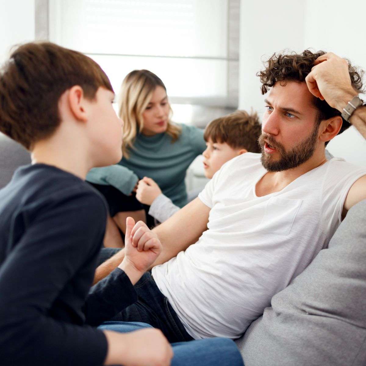 Mindful Healing Family Therapy in New Jersey family talking on the couch with mom, dad, and two sons