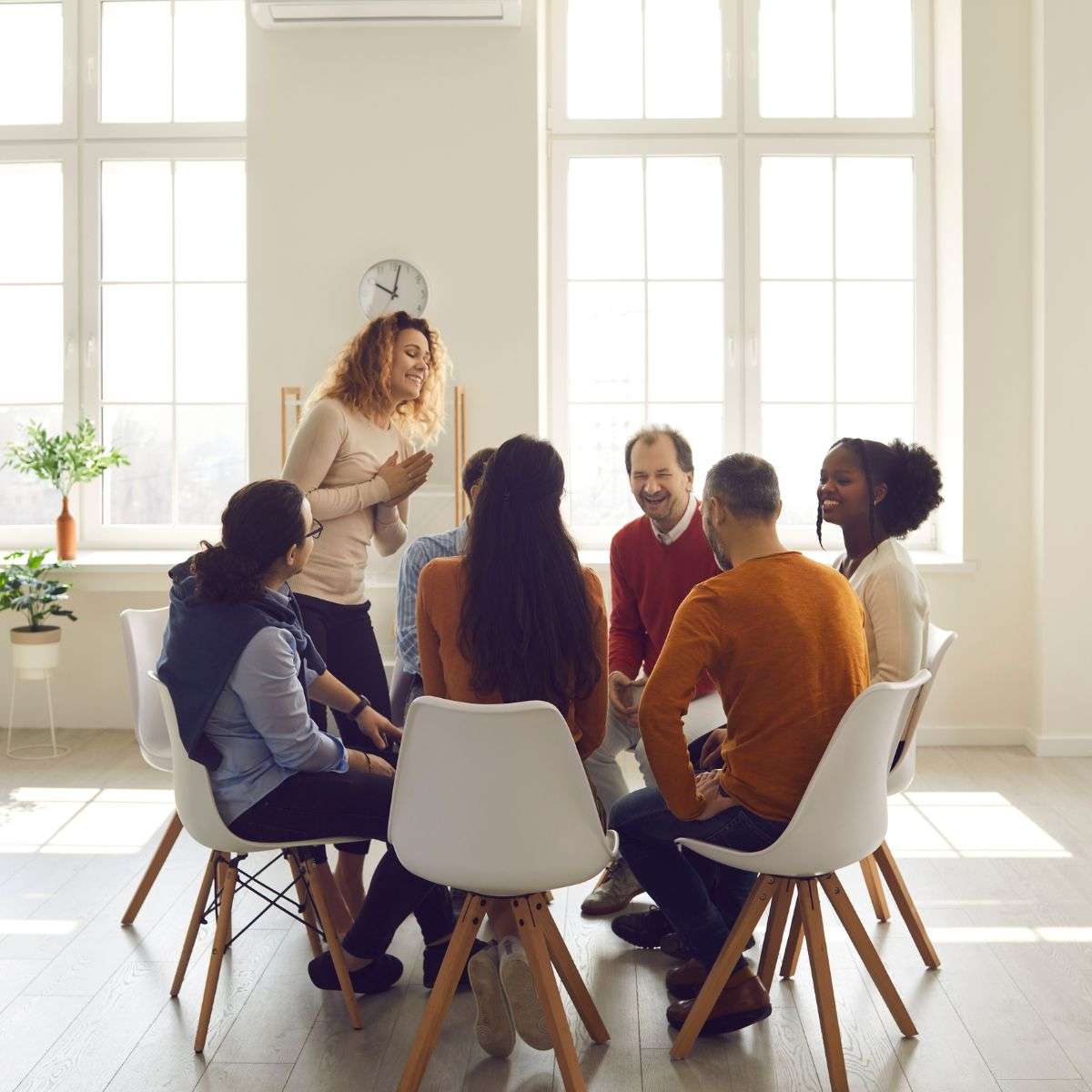 Mindful Healing Group Therapy in New Jersey diverse group of people talking in an open room, each sharing their experiences