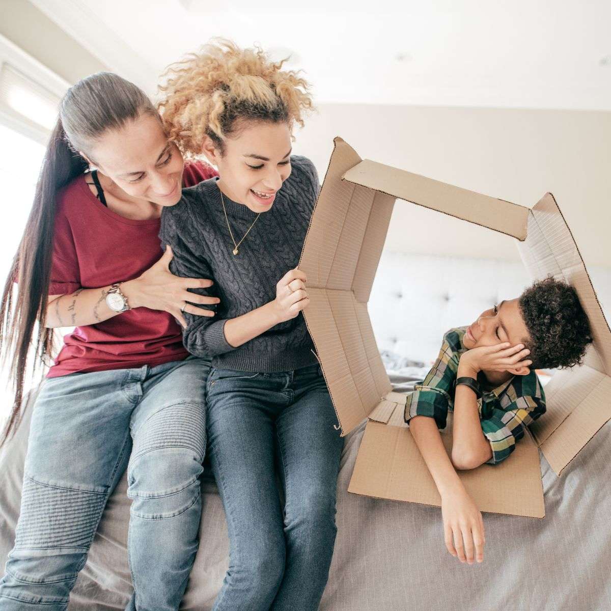 Mindful Healing LGBTQ Therapy in New Jersey Two moms playing with their son and a cardboard box
