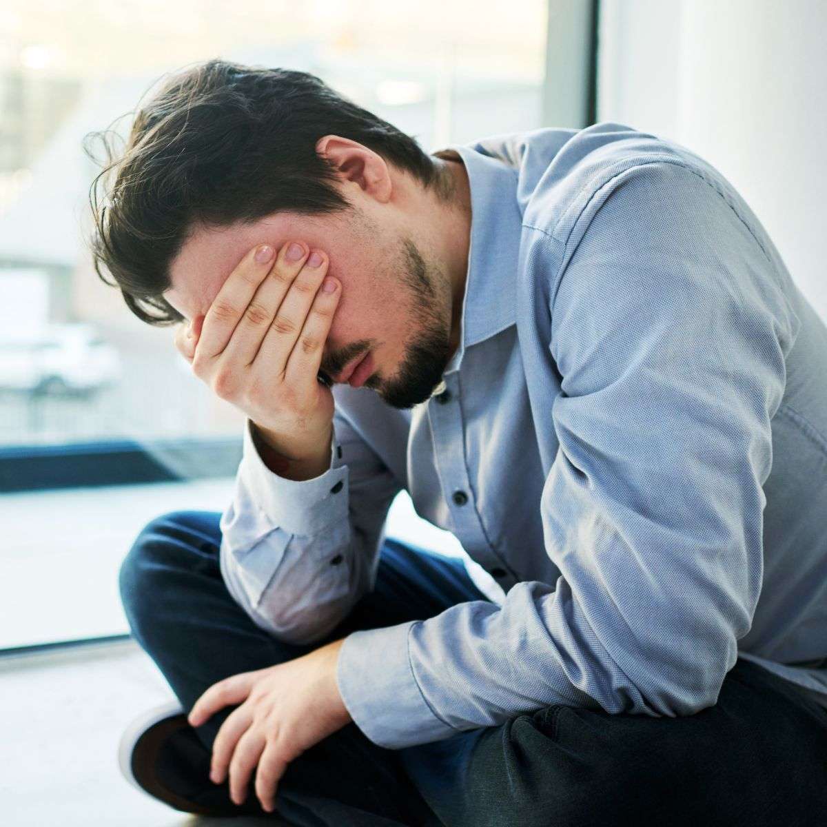 Mindful Healing PTSD Treatment in New Jersey Man holding his head as he is obviously overwhelmed and struggling with a bad situation