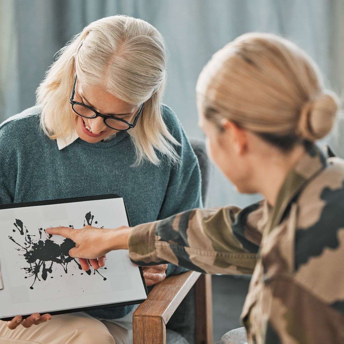 Mindful Healing PTSD Treatment in New Jersey female soldier talking to a therpist explaining what she sees in an ink blot picture