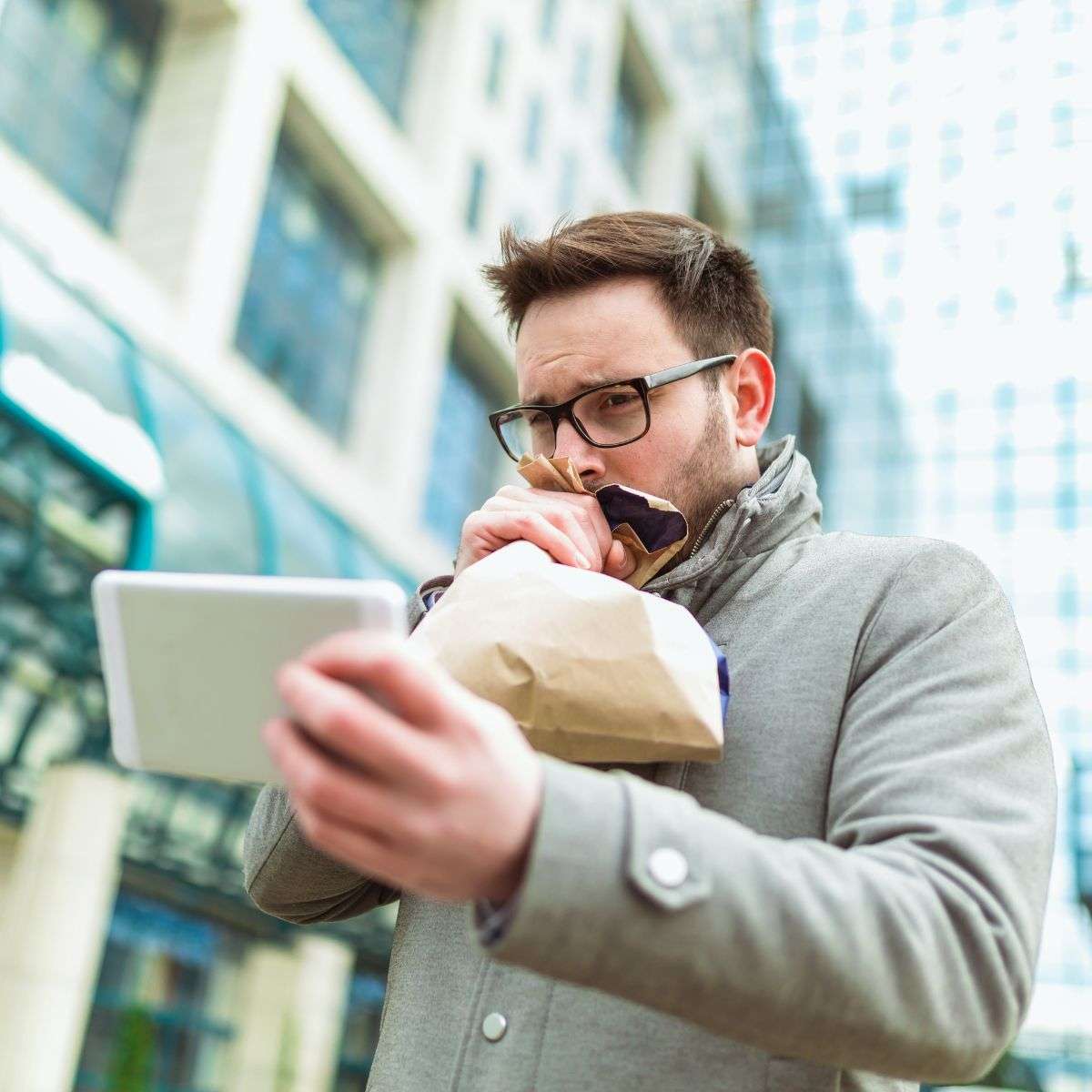 Mindful Healing Panic Attack Treatment in New Jersey man breathing into a bag to calm down while staring at his phone
