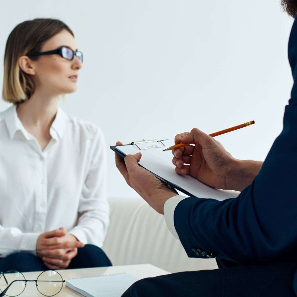 Mindful Healing Psychiatric Evaluation woman being evaluated by a male psychologist who is taking notes