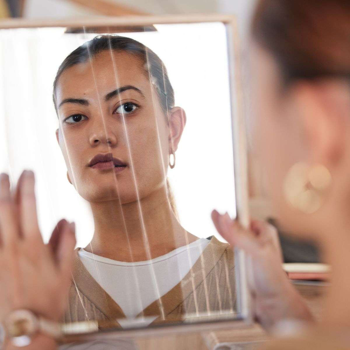 Mindful Healing Schizophrenia Treatment in New Jersey young latina woman looking at a broken mirror to see a broken reflection of herself