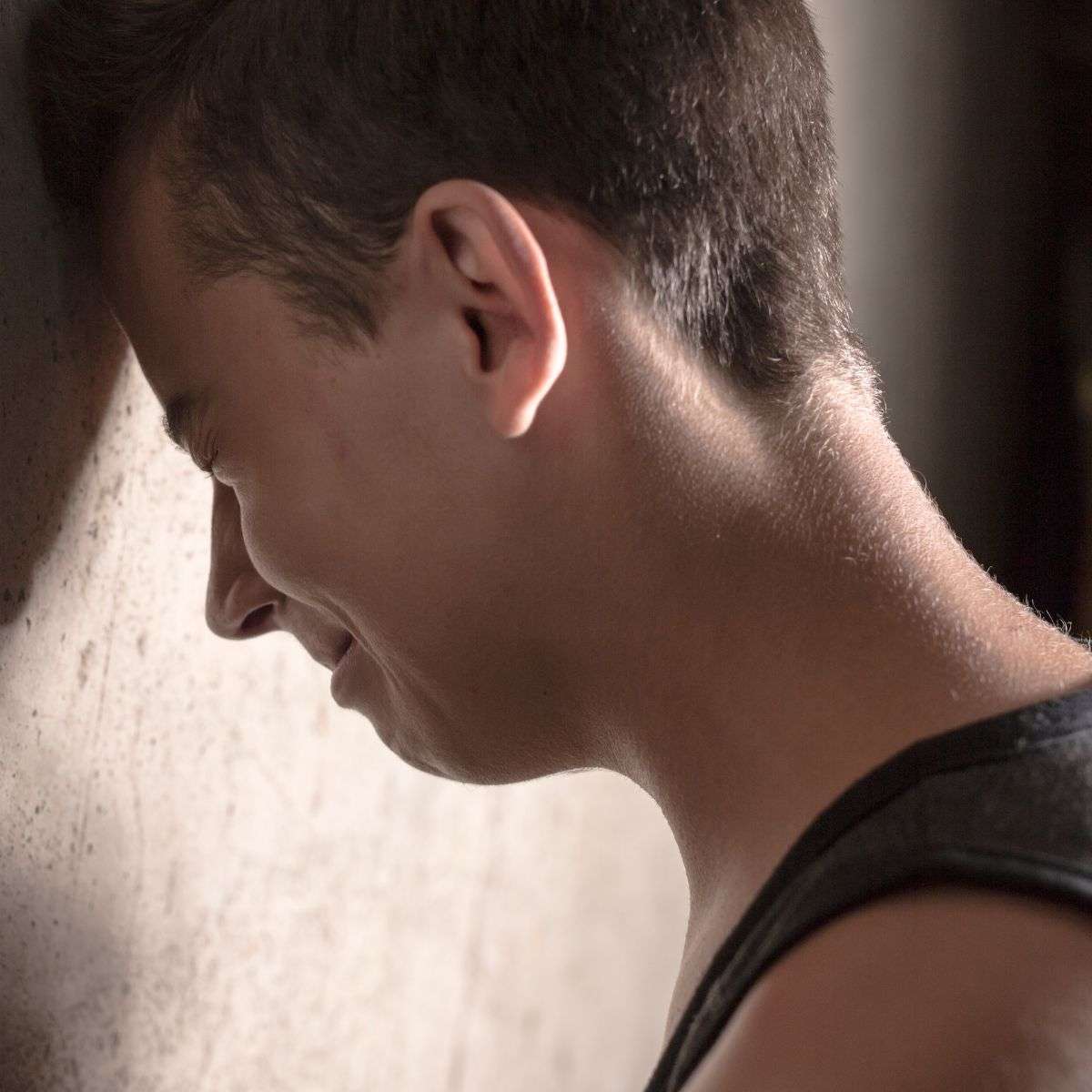 Mindful Healing Self Harm Treatment in New Jersey Teen boy hitting his head into a wall while crying and visibly stressed