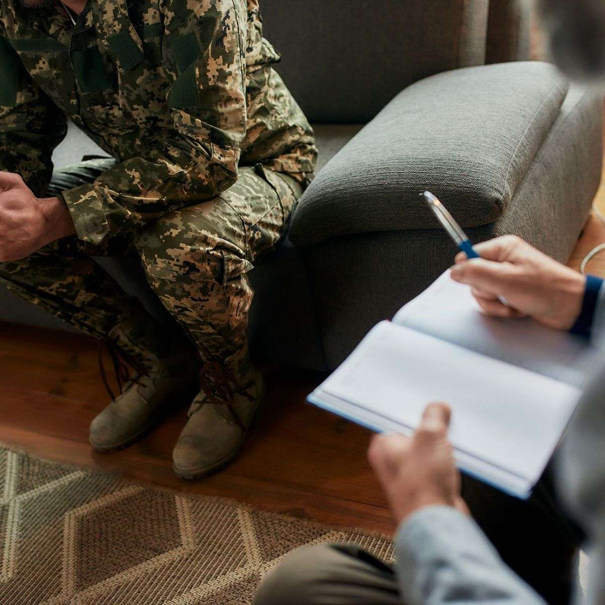 Mindful Healing Veteran Therapy in New Jersey a serviceperson sitting and talking with a therapist, while the therapist takes notes