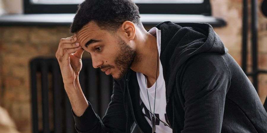 Mindful Healing Young man looking stressed out and trying to manage a traumatic experience